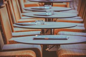 chairs and tables in a row in a restaurant close up