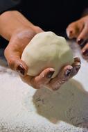 dough in the hands of a woman