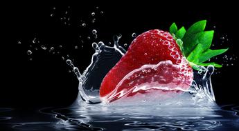 ripe strawberries in spray of water