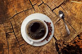 black coffee and coffee beans on the wooden table