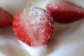 Cut ripe red strawberries in sugar