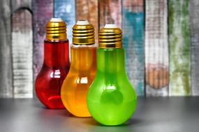 three multi-colored energy drinks in transparent bottles