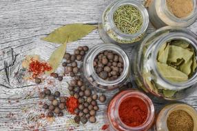 Spices in Jars at wooden table