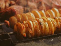 Close-up of the beautiful, grilled potato slices, on the skewers