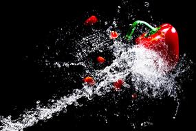 red paprika in water splash