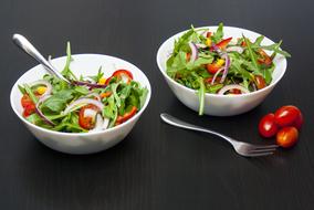 vegetable salad in two white bowls