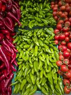 red and green chili peppers and red tomatoes on the counter