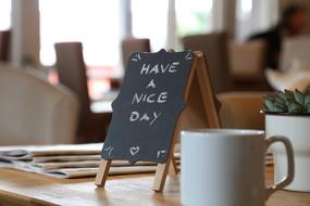 have a nice day on a table with coffee