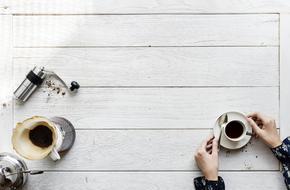 coffee grinder, ground coffee brew and a cup of coffee