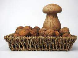 Beautiful wicker basket with the brown walnuts and patterned nutcracker