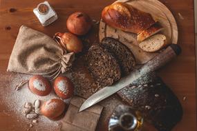 homemade bread, eggs, flour and onions on the kitchen table