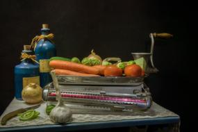 vegetables, meat grinder and bottles of oil on the kitchen table