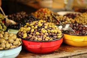 Colorful and beautiful olives in the bowls, for sale