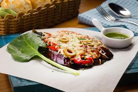 eggplant under cheese with pesto souse