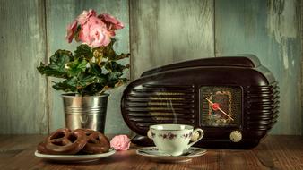 cup of tea with pretzels and a retro radio on the table