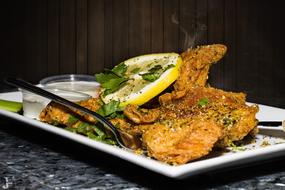 fried chicken wings with pepper and lemon