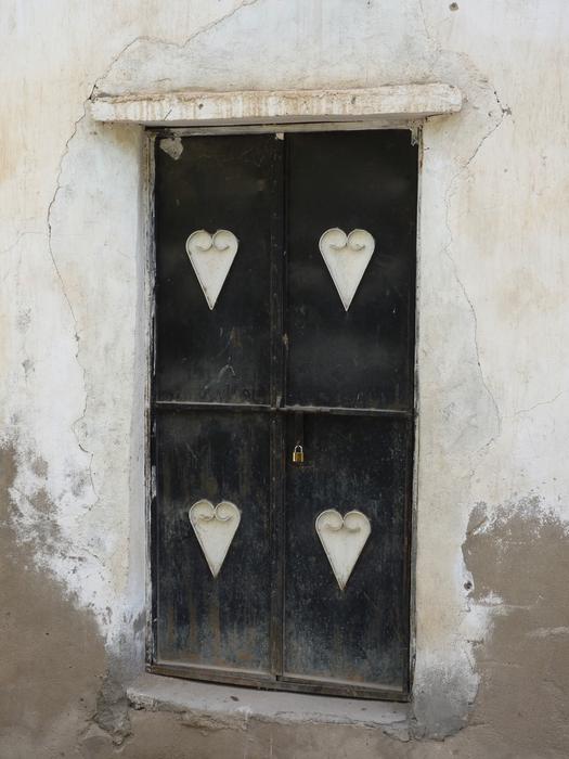 white hearts on black front doors, oman