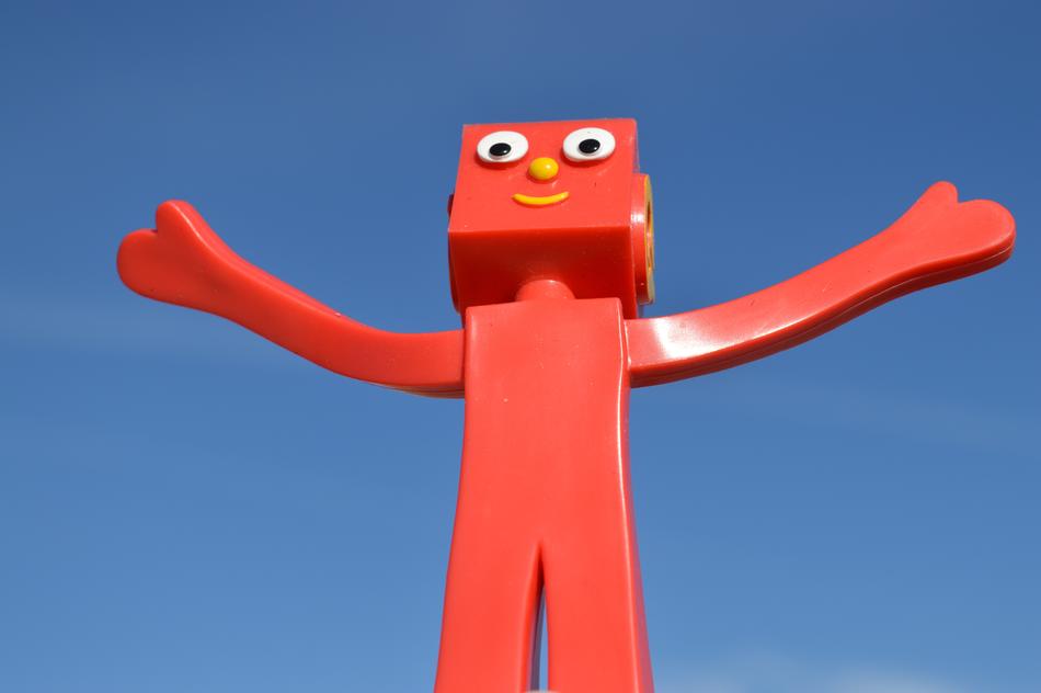 red cartoon hero on blue background