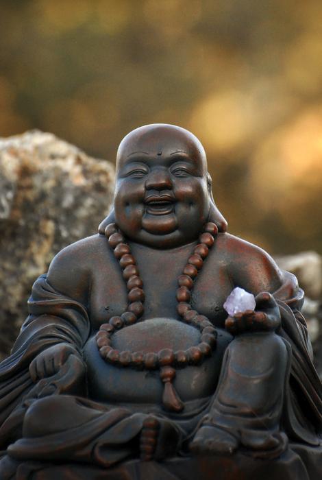 Zen, happy Buddha figurine at blur background