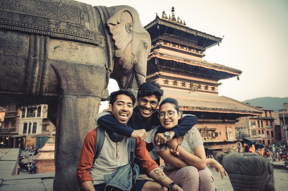 happy Friends, two asian boys and girl near temple