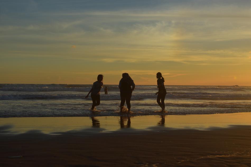 Friendship Silhouette on beach at Sunset