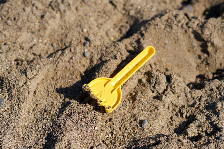 Yellow rake with sand free image download