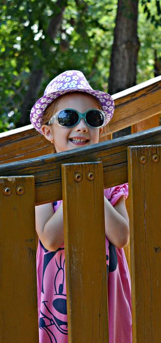 Happy Girl Child hide behind fence