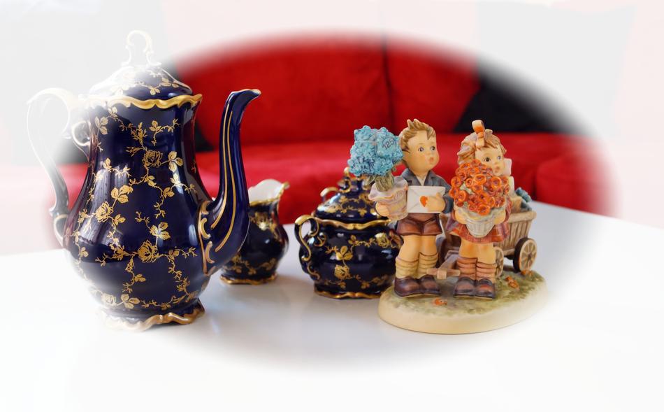 tea set with dolls on the table