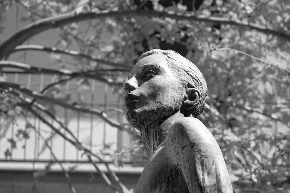 sculpture of a girl on the background of a park