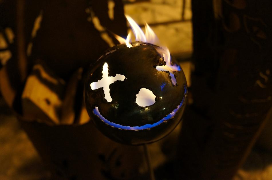 a black bomb with a face on fire