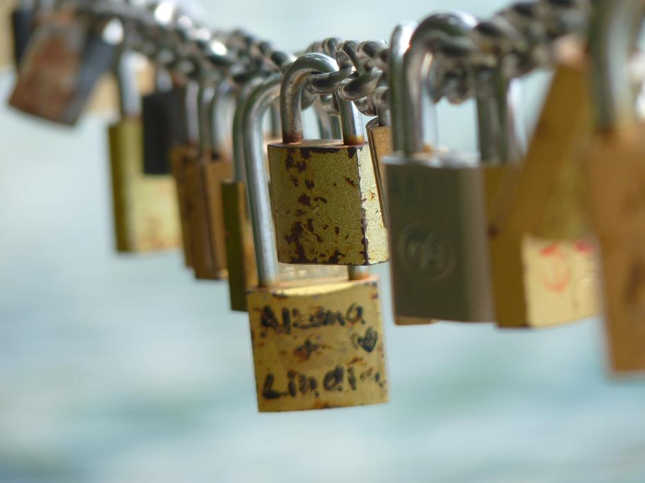 gold locks on an iron chain