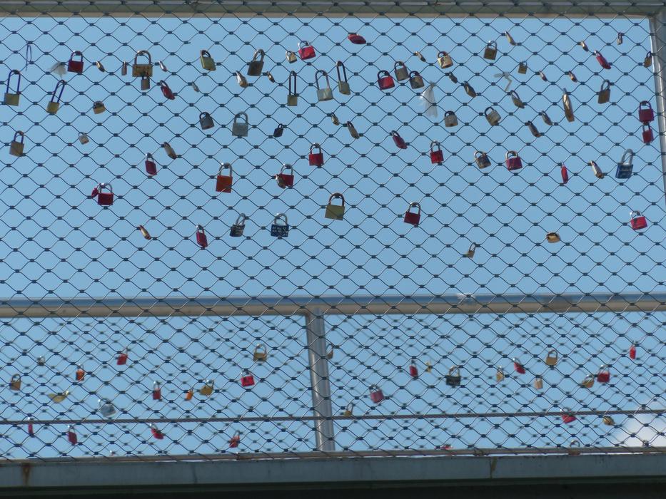 locks on the fence against the blue sky