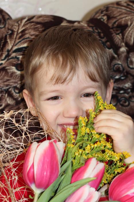 cute baby with a bouquet of flowers
