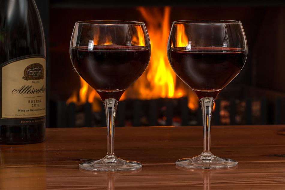 beautiful Red Wine Glasses near the fireplace