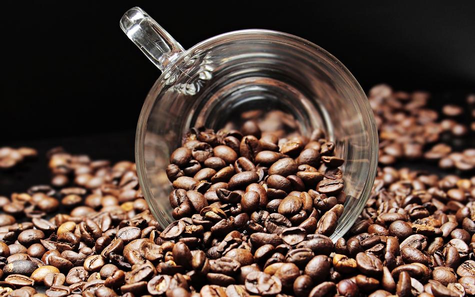 transparent cup among coffee beans