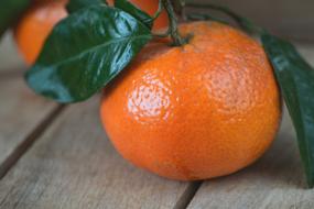 Mandarin on wooden table close up