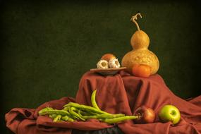 still life image of pumpkins, garlic, green pepper and apples