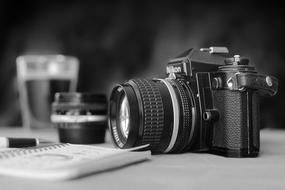 black and white image of a camera on the table