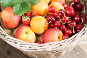 garden fruits and berries in a wicker basket