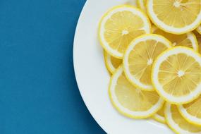 sliced lemons on a white plate