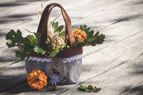 basket with autumn pumpkins and oak leaves