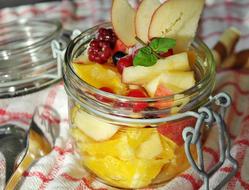 Beautiful and colorful fruit salad in the glass jar