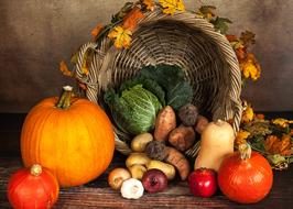 still life of autumn vegetables and wicker basket