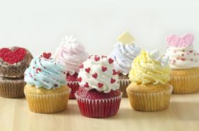 multi-colored cupcakes with cream