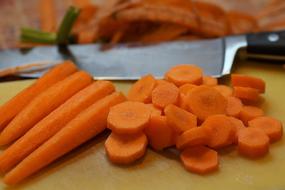 Beautiful, chopped, orange carrots, near the shiny knife