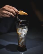Beautiful coffee drink with the ice and colorful decoration, in the hand