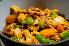 stewed vegetables in a plate on a blurred background