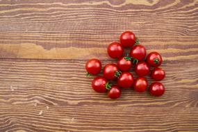 cherry tomatoes on the wooden surface