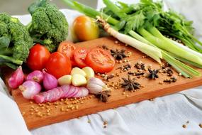 variety of colorful vegetables on wooden cutting board