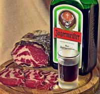 cappicola on a plate and liquor Jagermeister